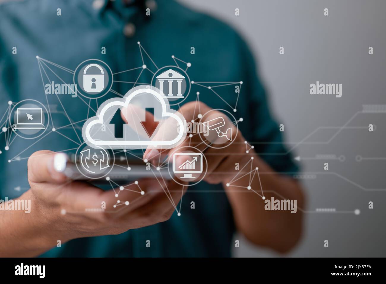 A guy uses a smartphone while holding a cloud computing diagram. Cloud computing, data storage, networking, and internet service principles. Stock Photo
