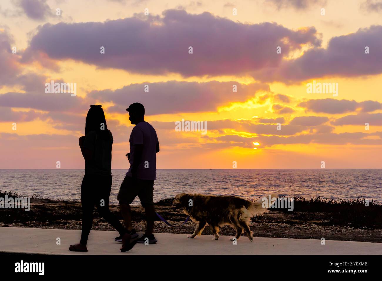 Haifa, Israel - September 05, 2022: Sunset scene on the Mediterranean Sea coast, with visitors silhouette. Haifa, Northern Israel Stock Photo
