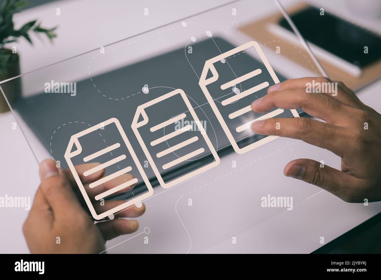 A paperless office is a concept based on electronic document management and a web-based documentation database. Working on a tablet computer, a busine Stock Photo