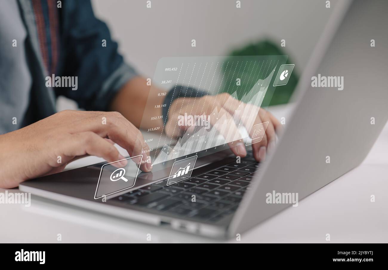 Business intelligence and big data analytics concepts. Financial graphs are displayed on a virtual screen. Stock Photo