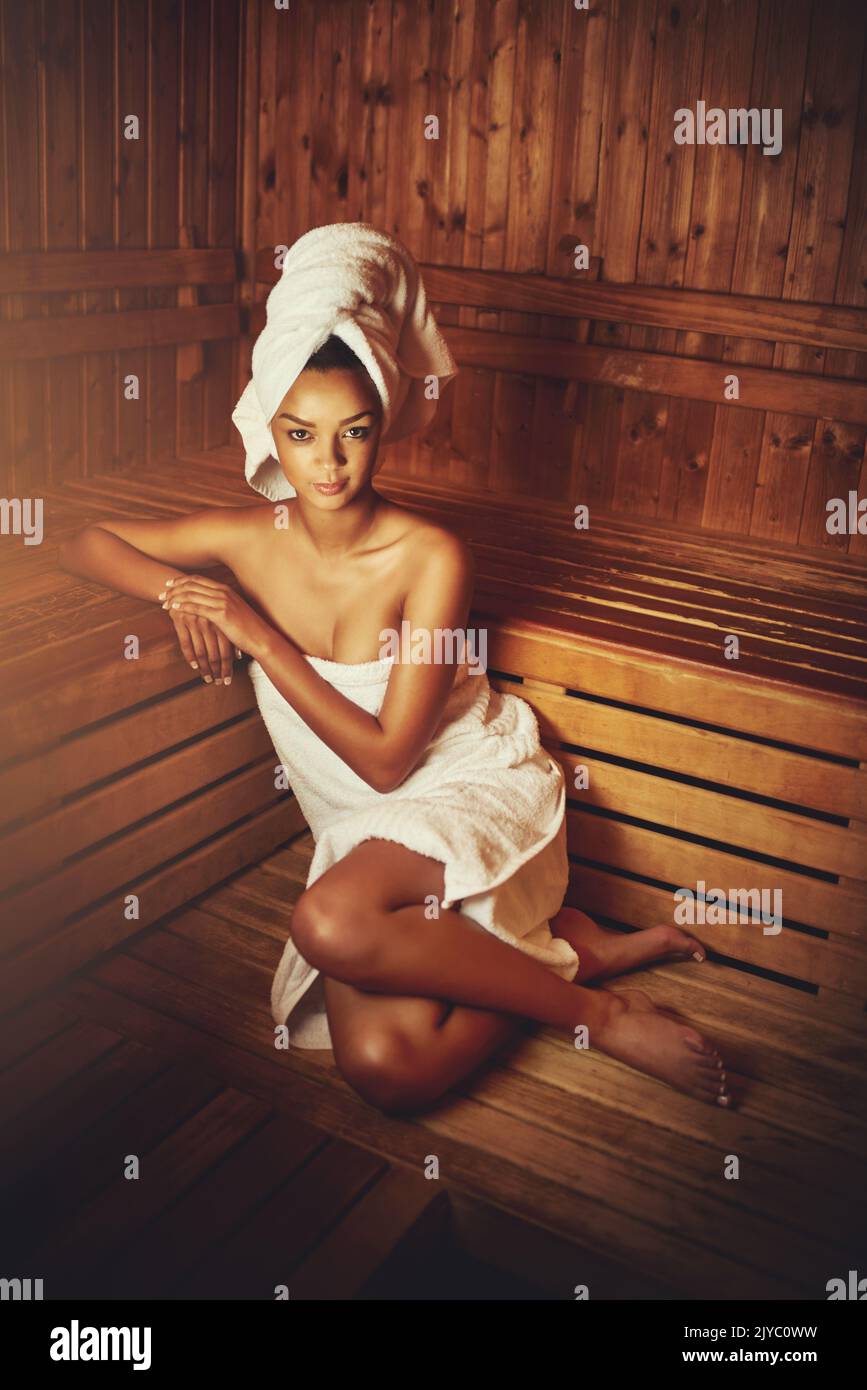 No stress today...Full length portrait of a young woman relaxing in the sauna at a spa. Stock Photo