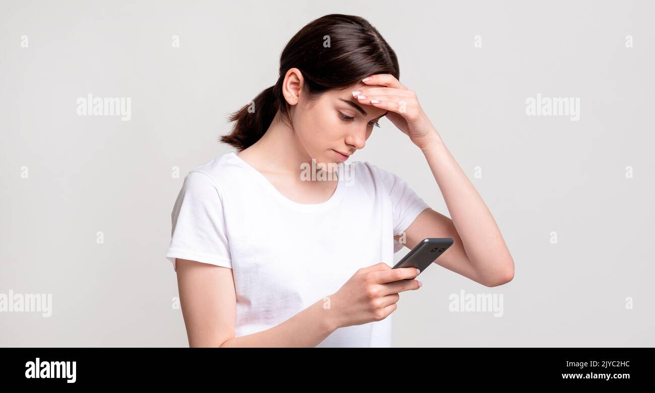 social media anxiety troubled woman smartphone Stock Photo