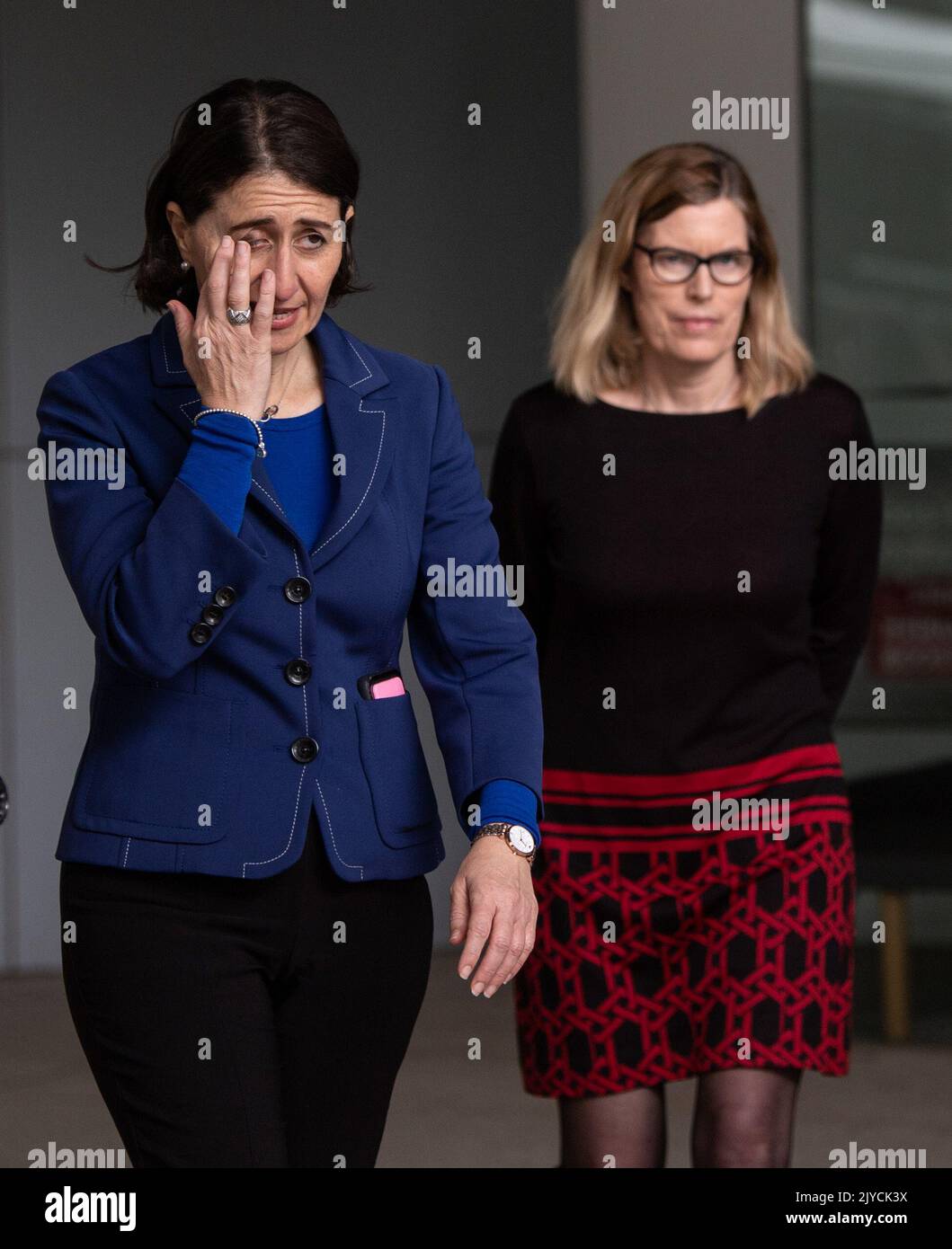 NSW Premier Gladys Berejiklian rubs her face as she leaves a press ...