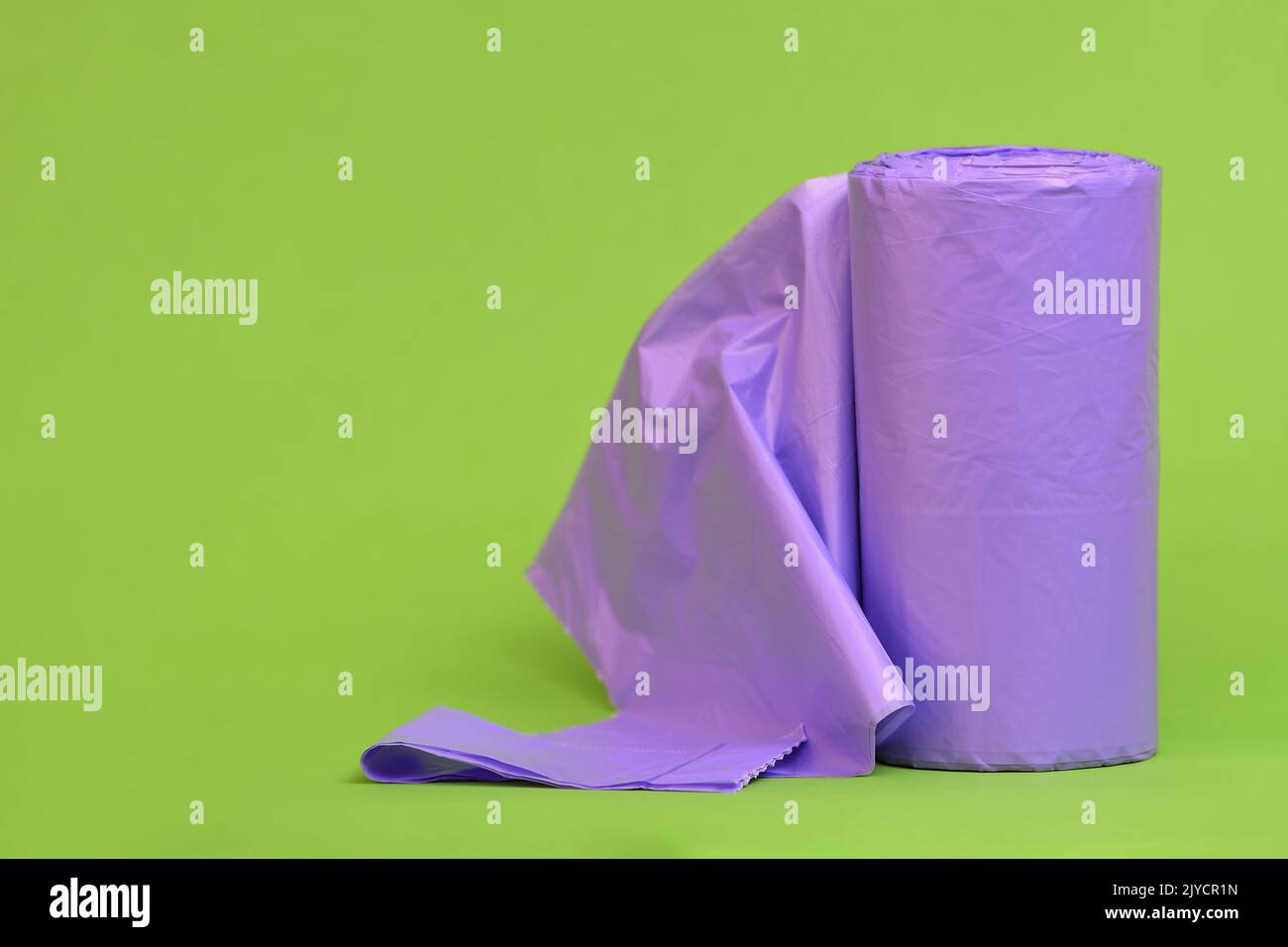 https://c8.alamy.com/comp/2JYCR1N/a-tightly-packed-roll-of-non-recyclable-purple-rubbishgarbagetrash-bag-with-the-first-bag-unfolded-on-a-lime-green-background-2JYCR1N.jpg
