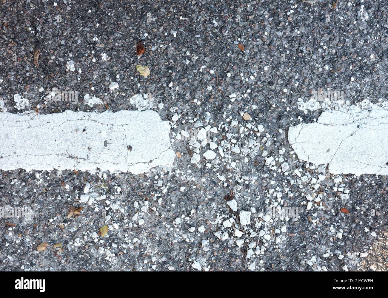 Black asphalt with broken white paint line, in need of maintenance Stock Photo