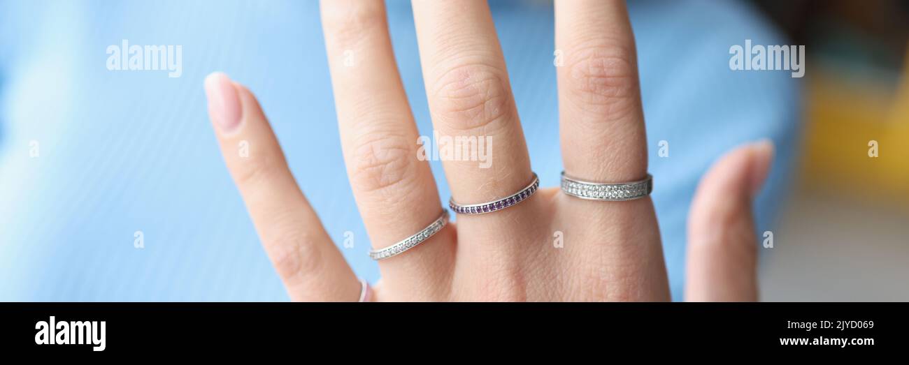 Woman hand with beautiful thin silver rings Stock Photo