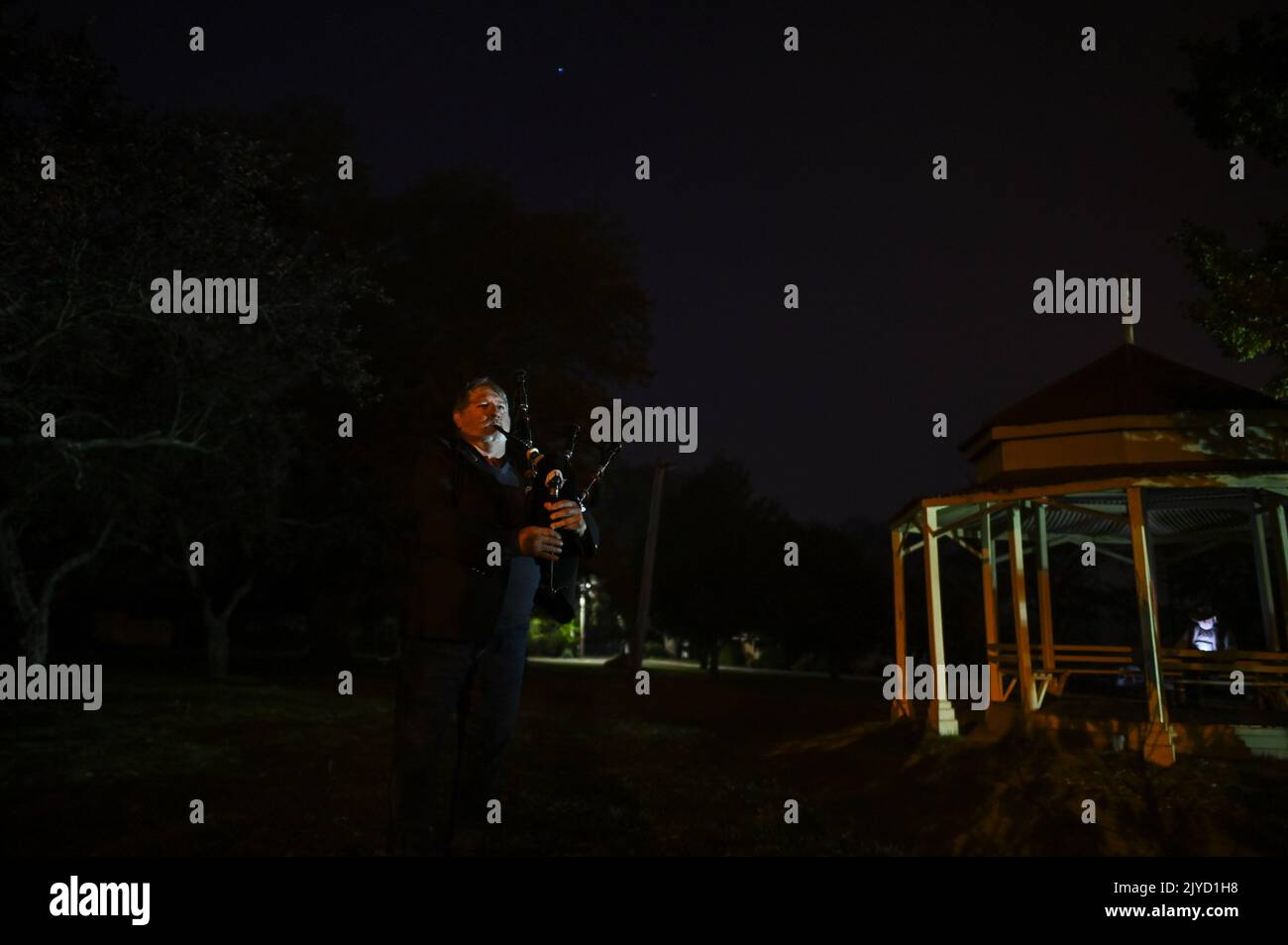 Christopher Nelson of the Braidwood RSL plays the bagpipes at dawn