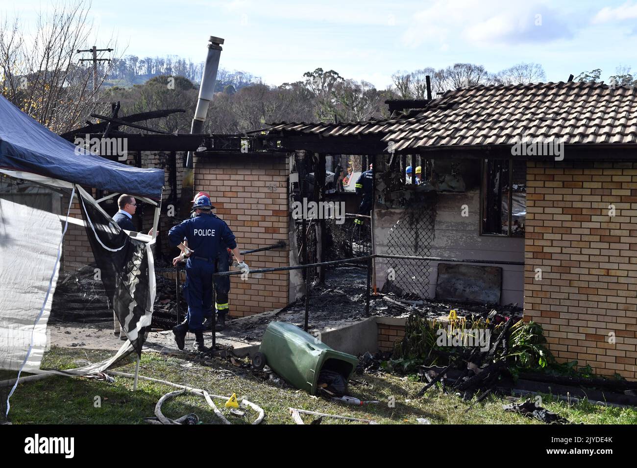 Fire investigators and forensic services at the scene of a house fire
