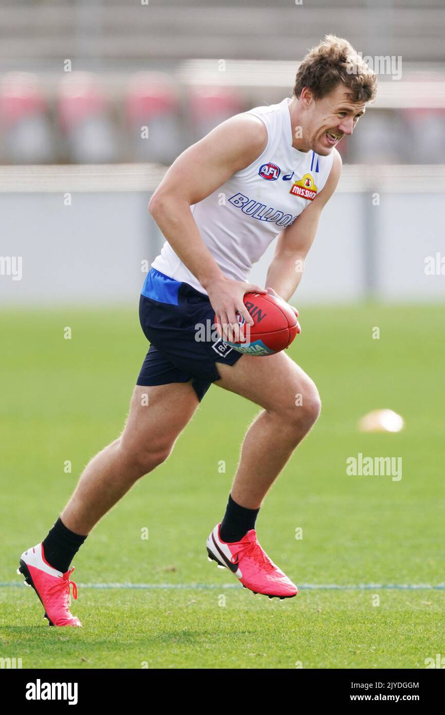 Jackson Macrae of the Bulldogs runs with the ball during an AFL Bulldogs training session at VU