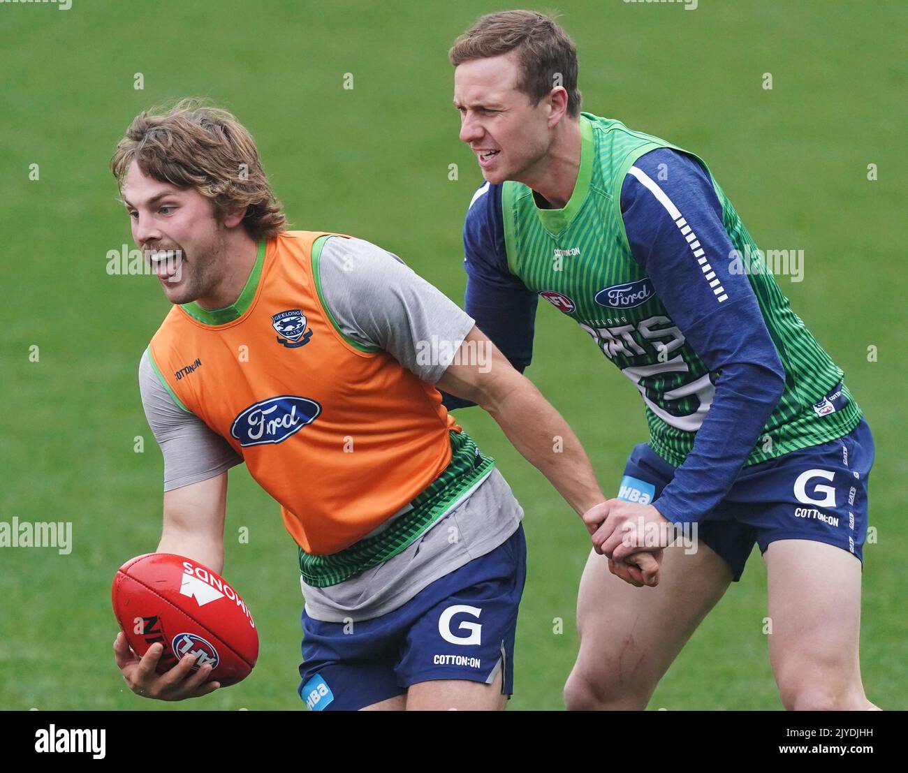Mitch Duncan of the Cats tackles Tom Atkins of the Cats during an AFL