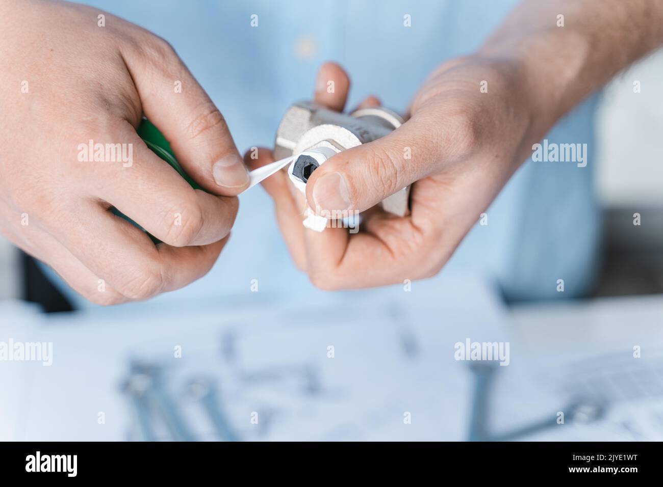 Man repairer,plumber using thread seal tape for reducer sealing