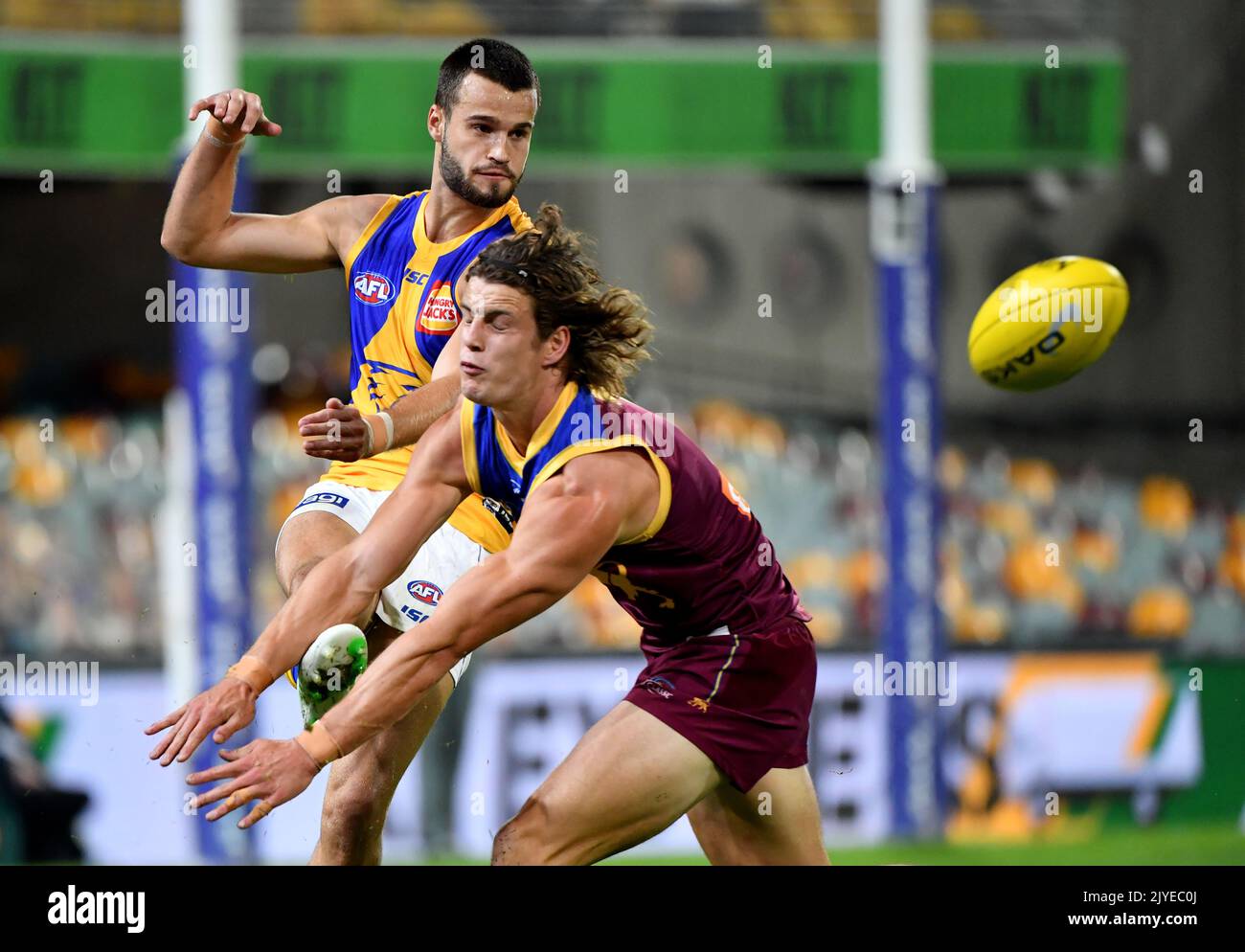 Josh Rotham Josh Rotham (left) of the Eagles gets his kick away during the Round 3 ...