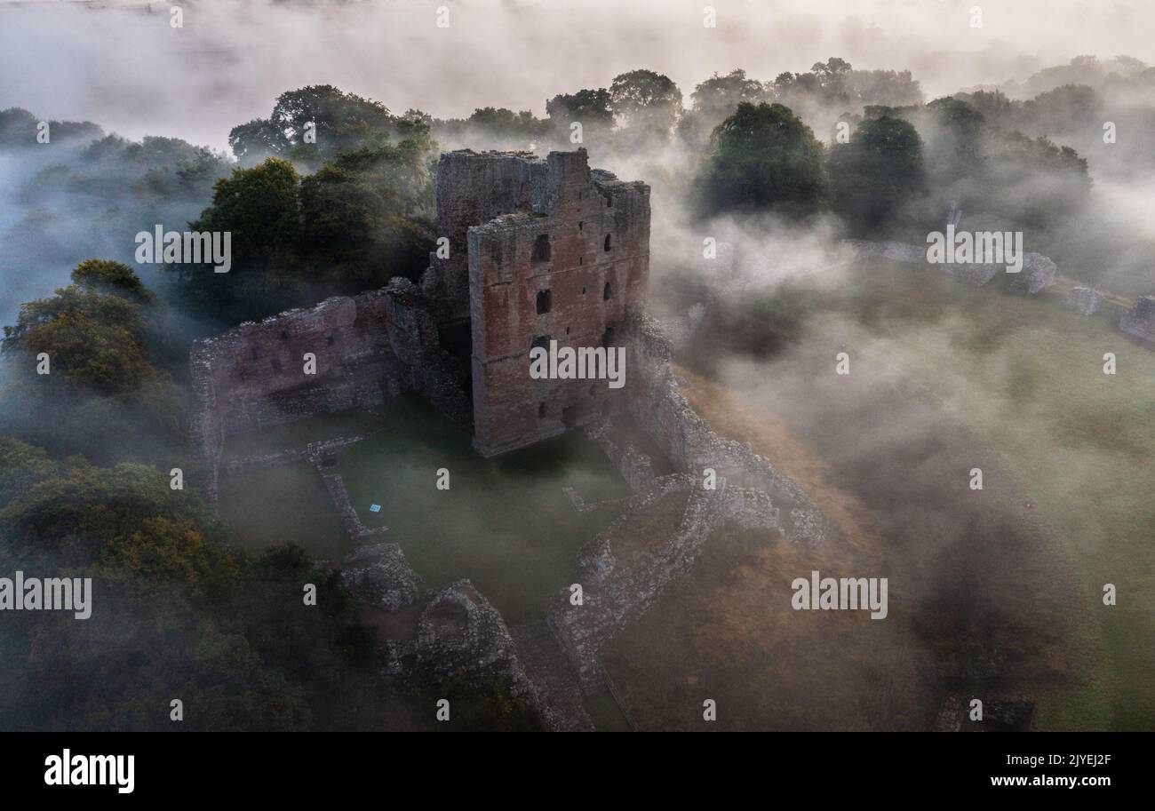 Norham Castle rising through the early morning mist Stock Photo