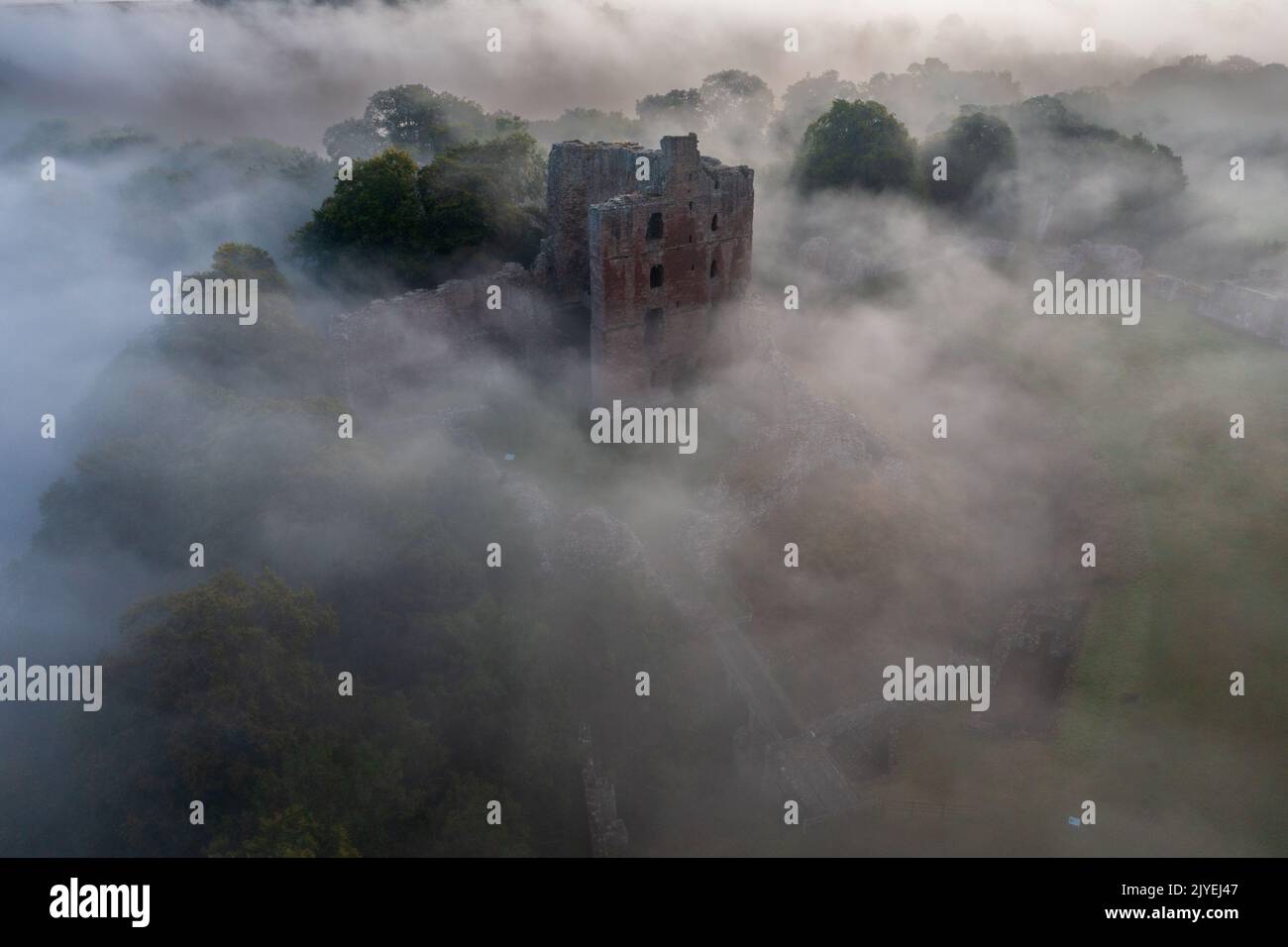 Norham Castle rising through the early morning mist Stock Photo