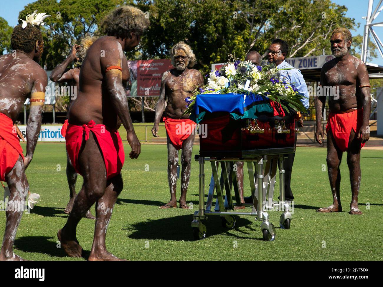 Indigenous performers surround the coffin of former Member for Arnhem