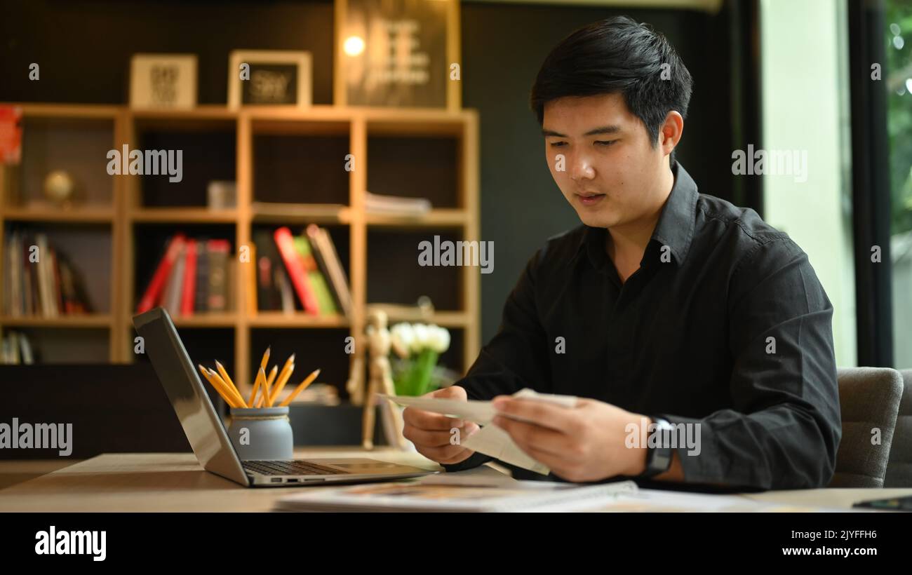 Asian man interior designers working with laptop and color palette ...