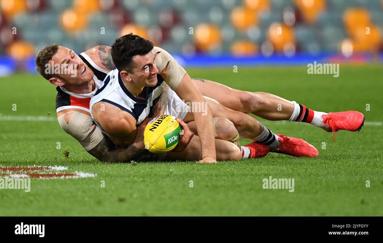 Mark O'Connor (right) of the Cats is tackled by Tim Membrey (left) of ...