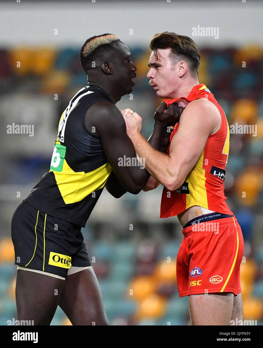 Mabior Chol (left) of the Tigers grapples with Caleb Graham (right) of the  Suns during the Round 12 AFL match between the Richmond Tigers and Gold  Coast Suns at the Gabba in