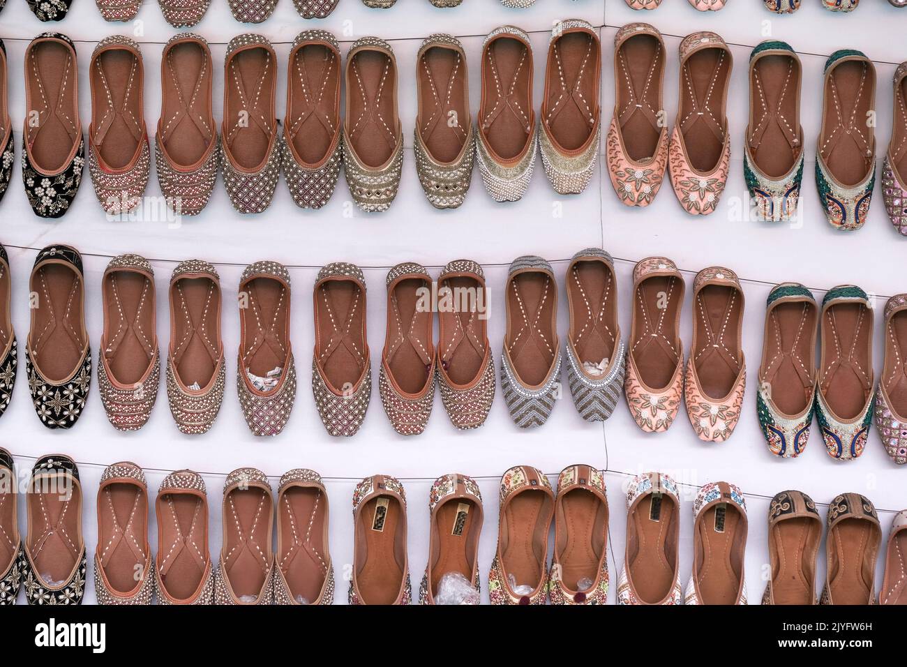 Colorful Handmade chappals (sandals) being sold in an Indian market, Handmade leather slippers, Traditional footwear. Stock Photo