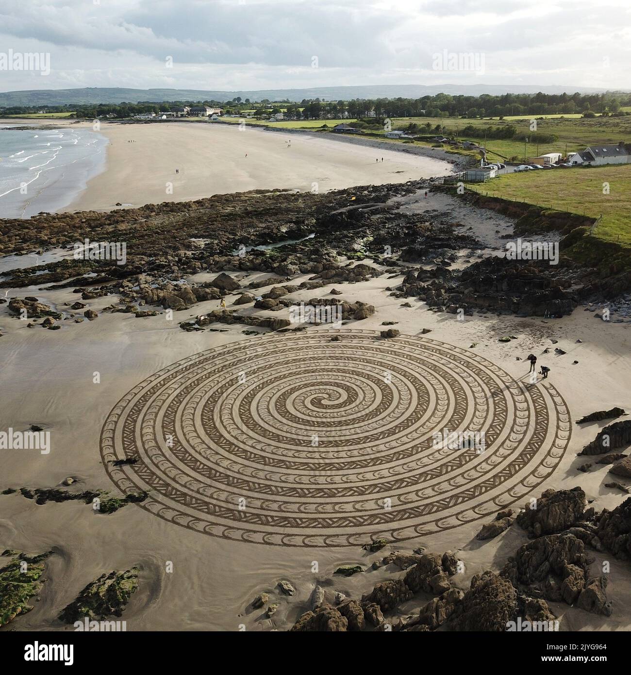 A stunning spiral. Ireland, UK: FROM PSYCHEDELIC patterns to a giant-sized pooch-portraits these are the best of sand art masterpieces to have popped- Stock Photo