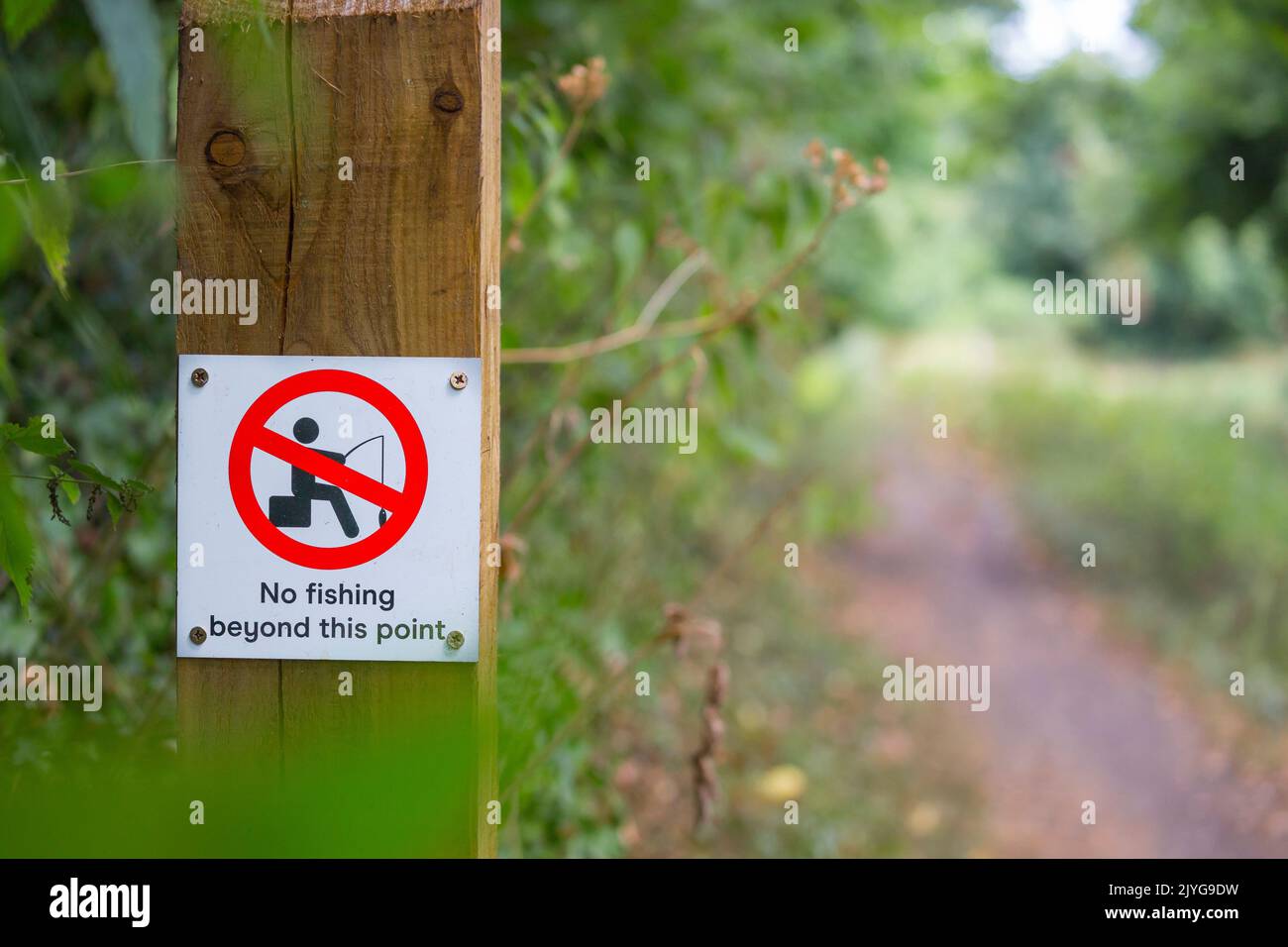 Close up of 'No fishing beyond this point' sign on a deserted UK canal