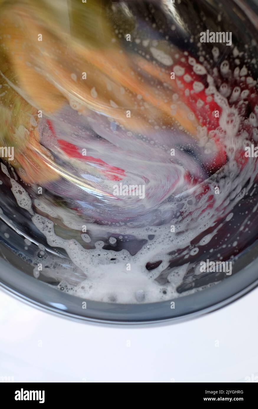 clothes spinning in washing machine Stock Photo