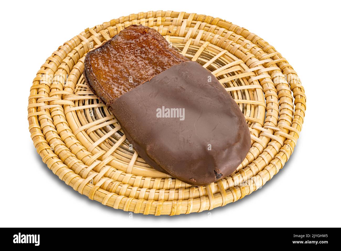 Single solar dried flat banana dipped melted chocolate on bamboo mat isolated on white background with clipping path. Stock Photo