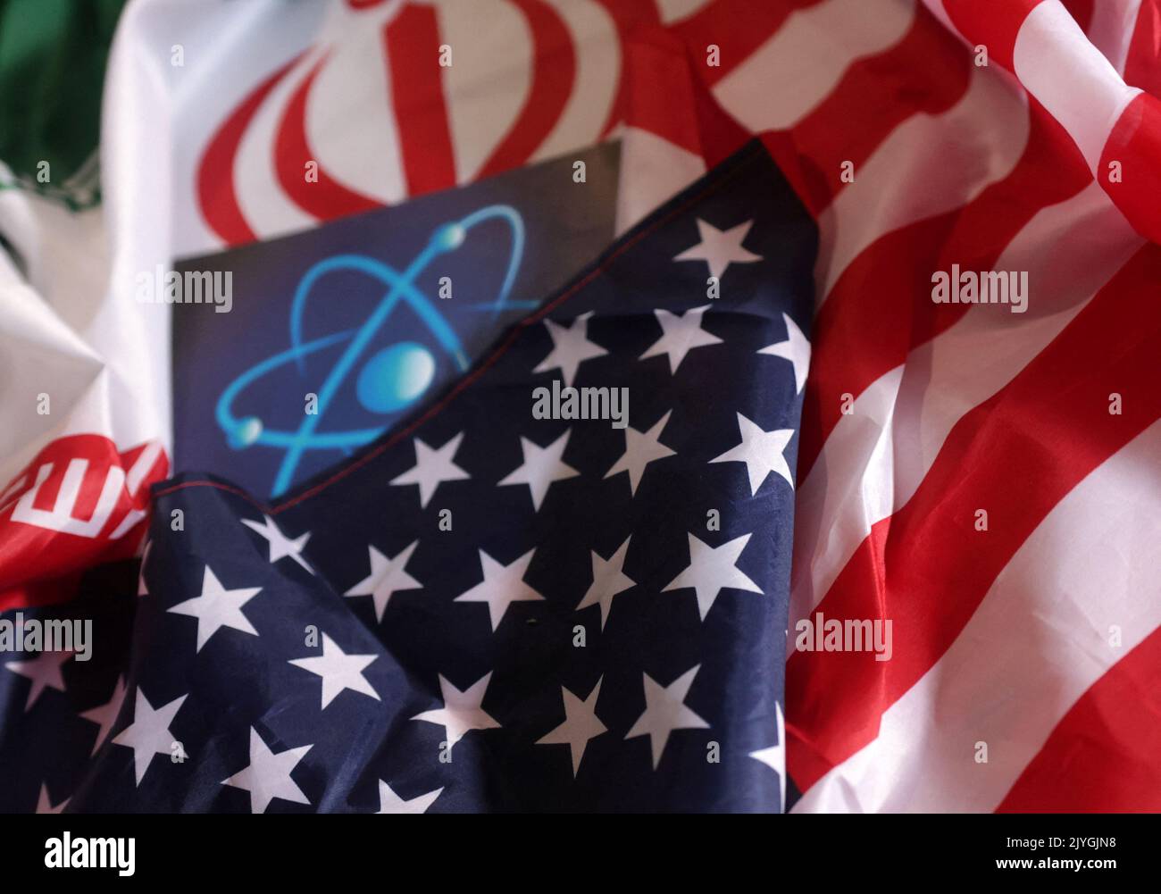 Atomic symbol and USA and Iranian flags are seen in this illustration taken September 8, 2022. REUTERS/Dado Ruvic/Illustration Stock Photo