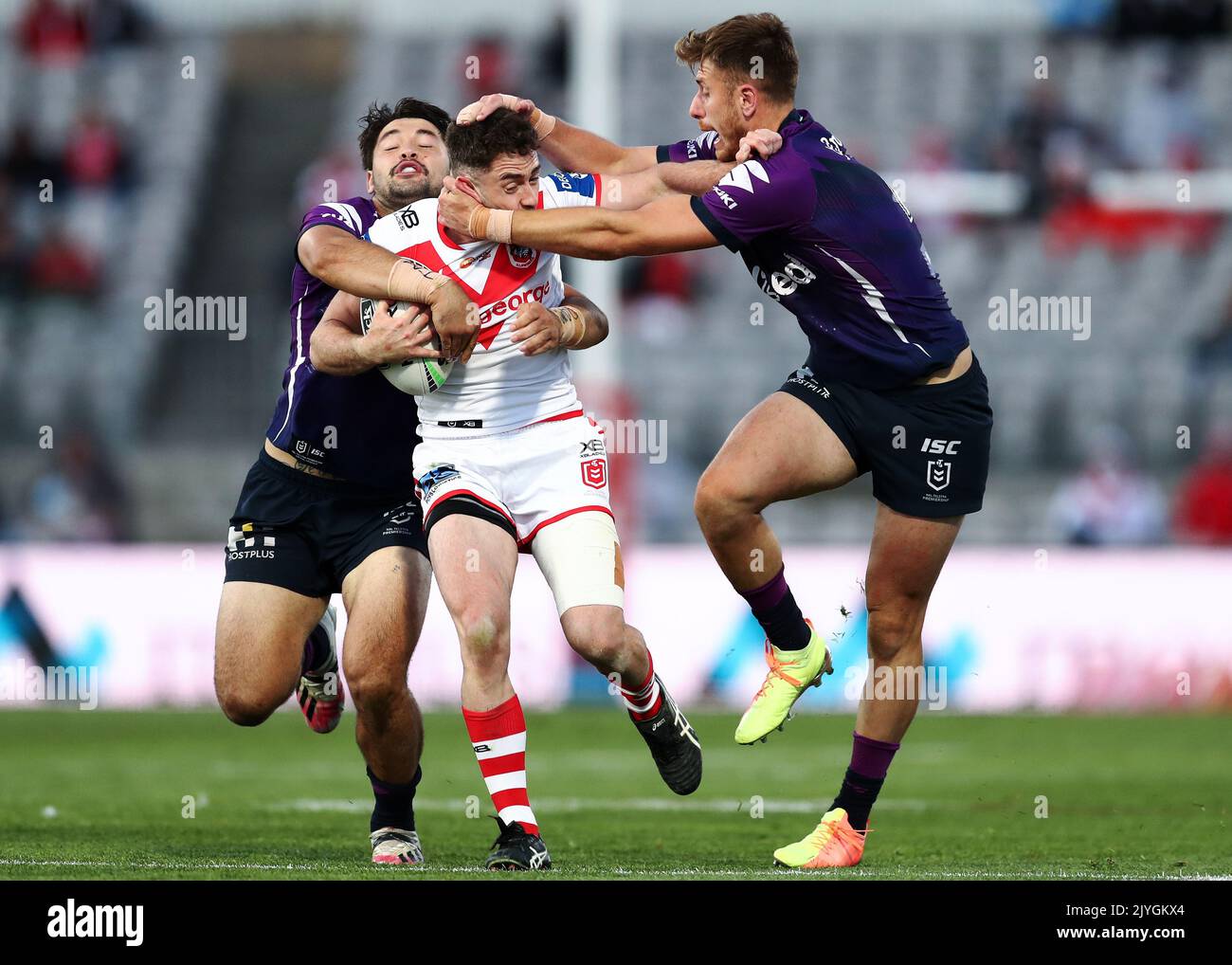 Adam Clune of the Dragons is tackled by the Storm defence during the ...