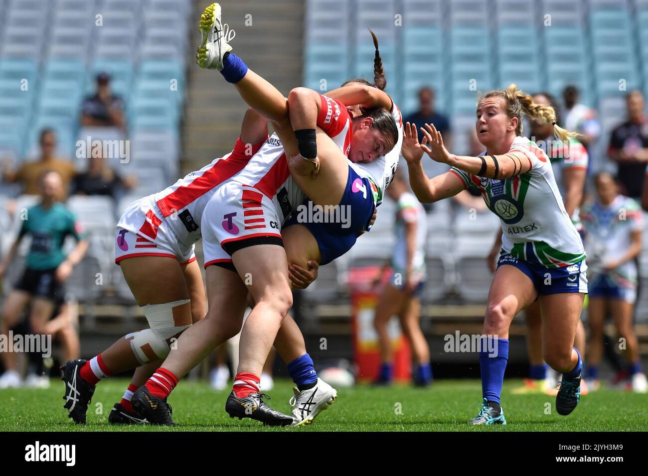 Samantha Economos of the Warriors is tackled by Christine Pauli of the  Dragons during the NRLW match between the St. George Illawarra Dragons and  the New Zealand Warriors at ANZ Stadium in