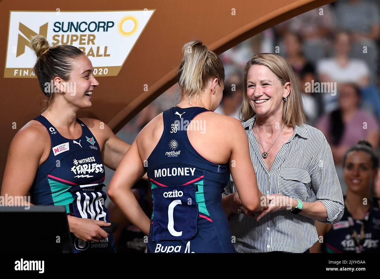 Melbourne Vixens head coach Simone McKinnis presents co-captains Liz Watson  and Kate Moloney their winners medal during the Super Netball Grand Final  between the Melbourne Vixens and West Coast Fever at Nissan