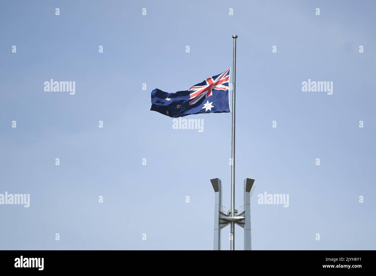 The Australian flag is seen flying at halfmast at Parliament House in