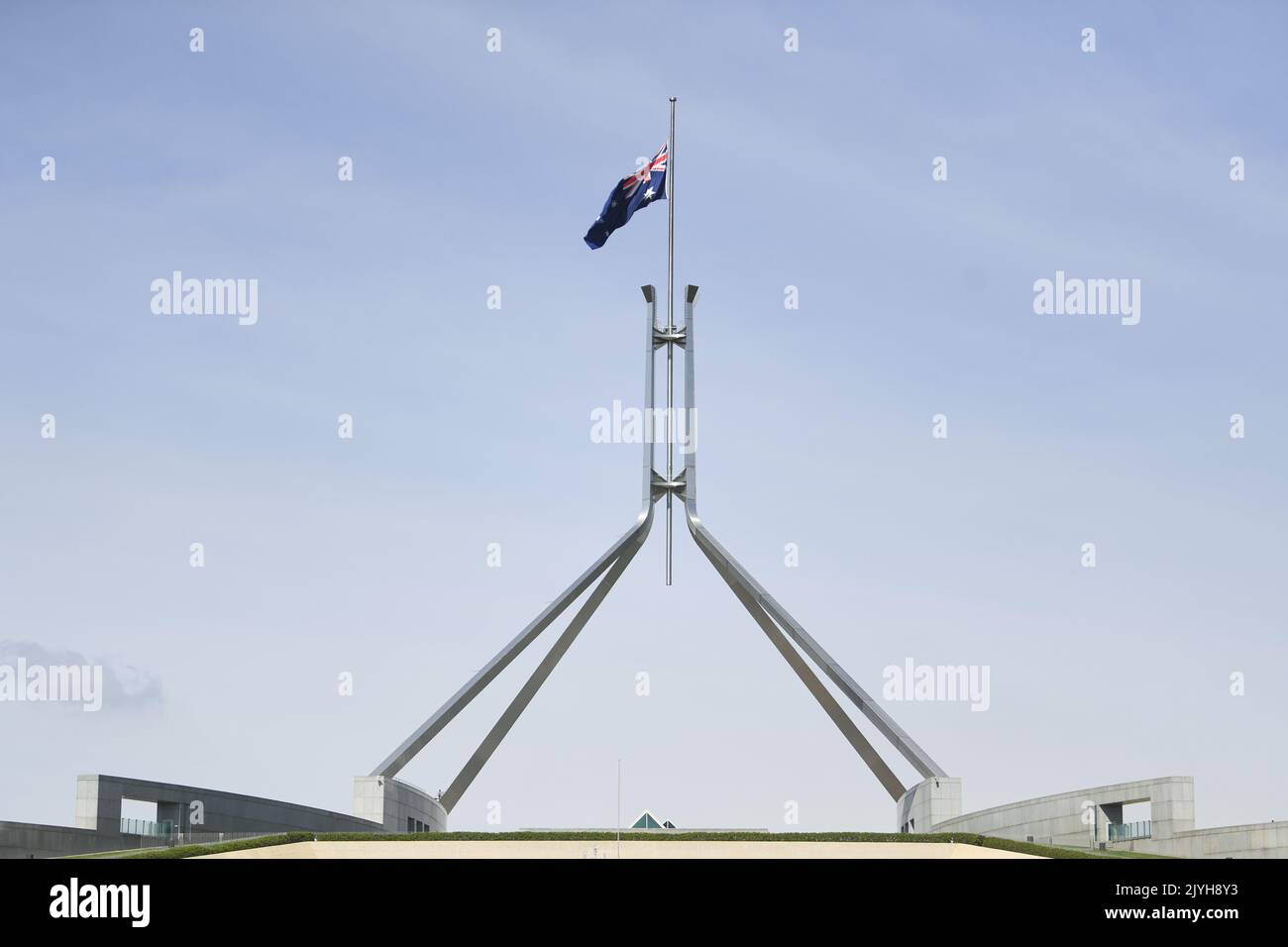 The Australian flag is seen flying at halfmast at Parliament House in