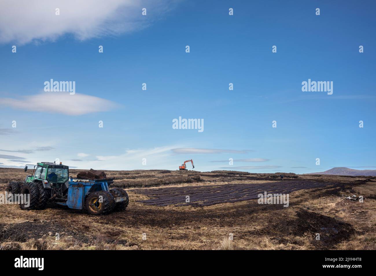 A digger and a hopper on a bog at the coast of West-Ireland Stock Photo