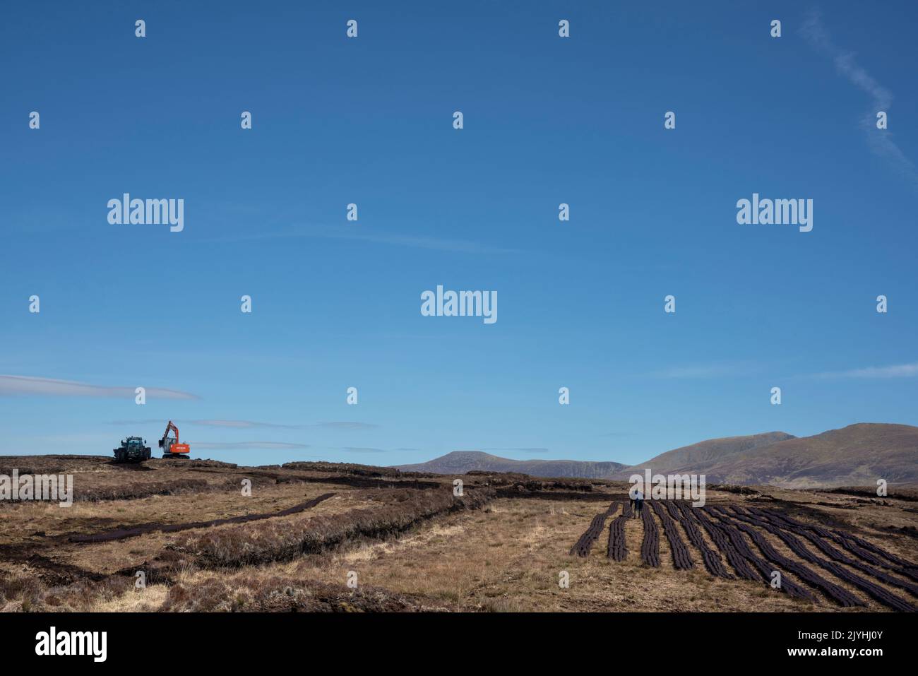 A digger and a hopper on a bog at the coast of West-Ireland Stock Photo