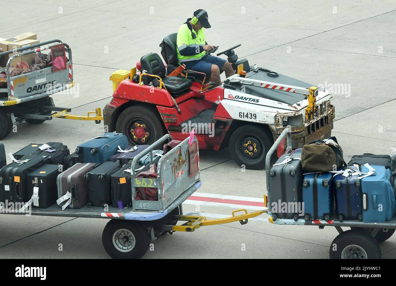 A Qantas baggage handler is seen at the Brisbane Domestic Airport in