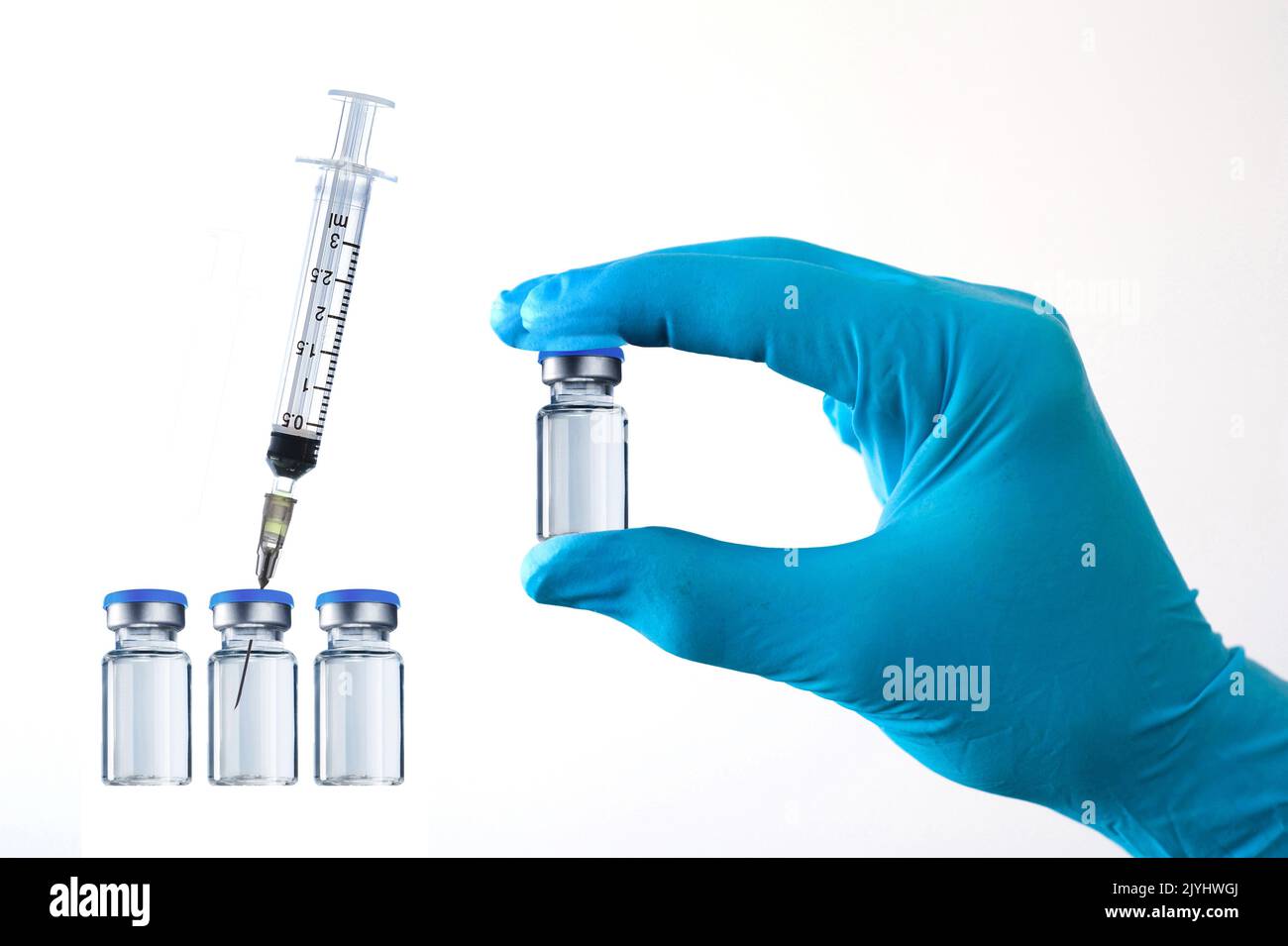hand in gloves holding a glass with vaccine, injections, cut out Stock Photo
