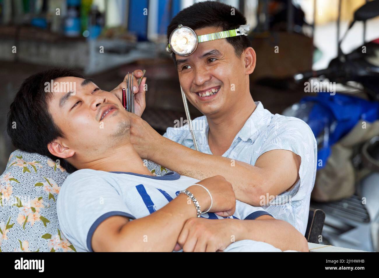 Ear cleaning in barber shop, Hai Phong, Vietnam Stock Photo Alamy