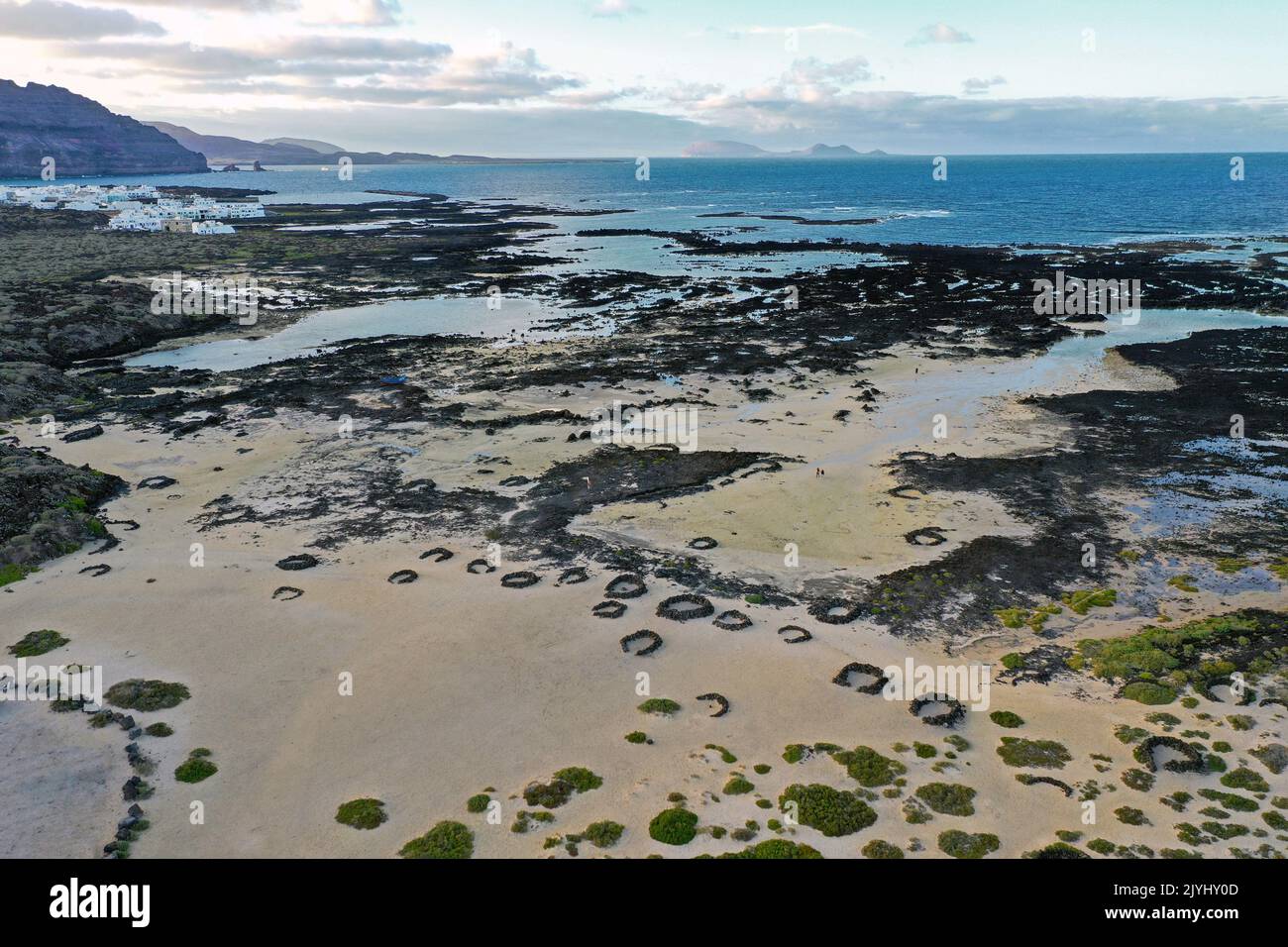 Rocky coast and beach bei Charca de la Novia, aerial view, Canary Islands, Lanzarote, Orzola Stock Photo