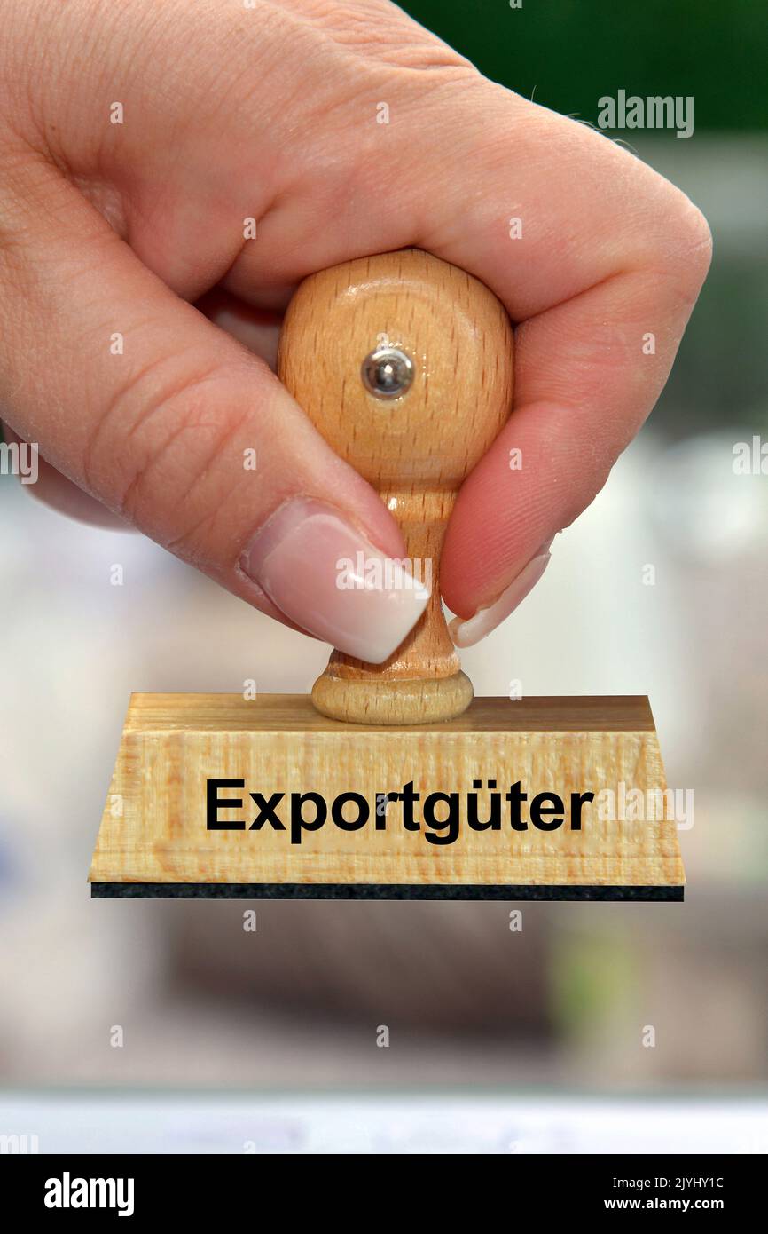 woman's hand with stamp lettering Exportgueter, export goods, Germany Stock Photo