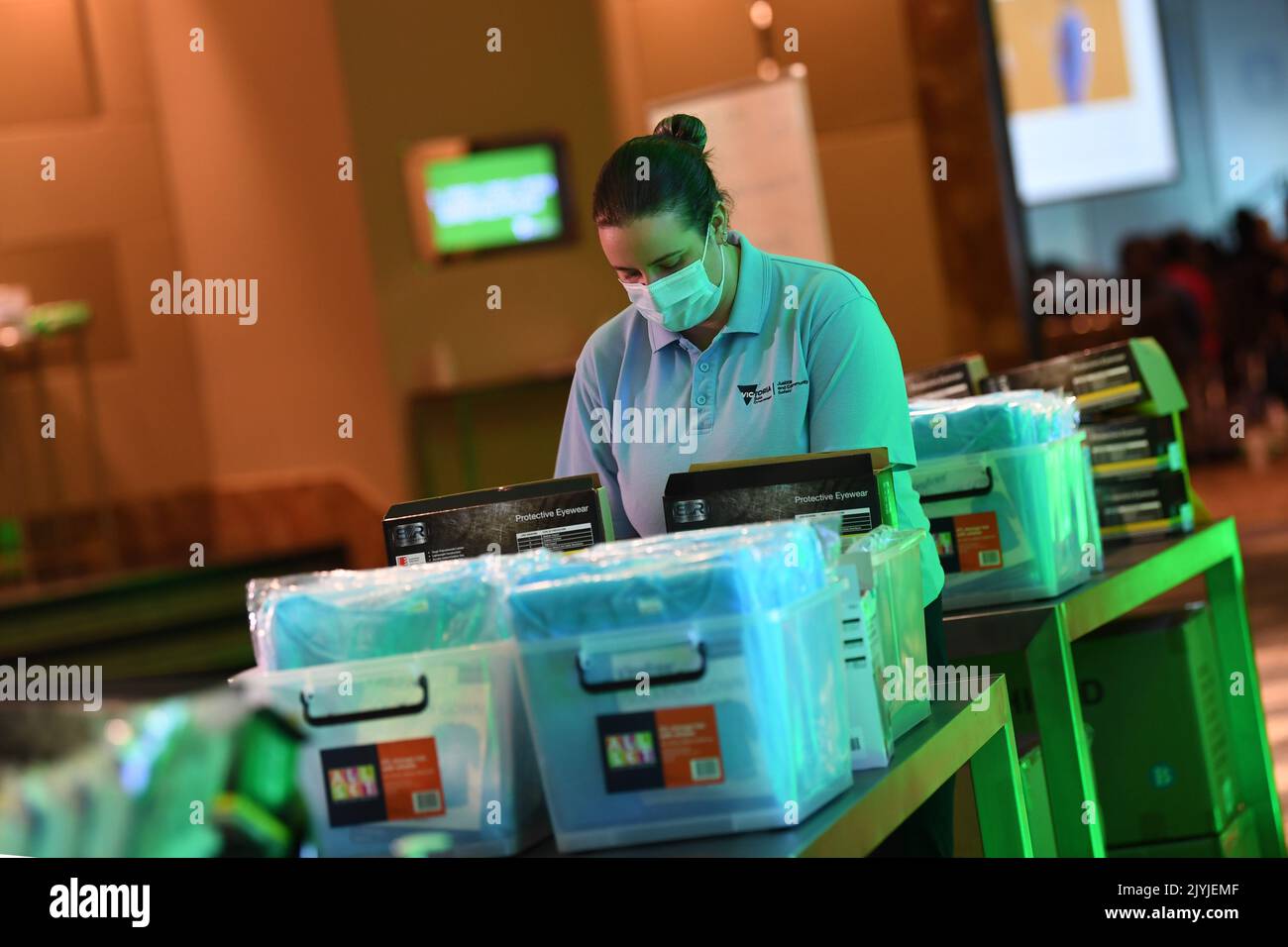 Healthcare workers are seen at a personal protective equipment station
