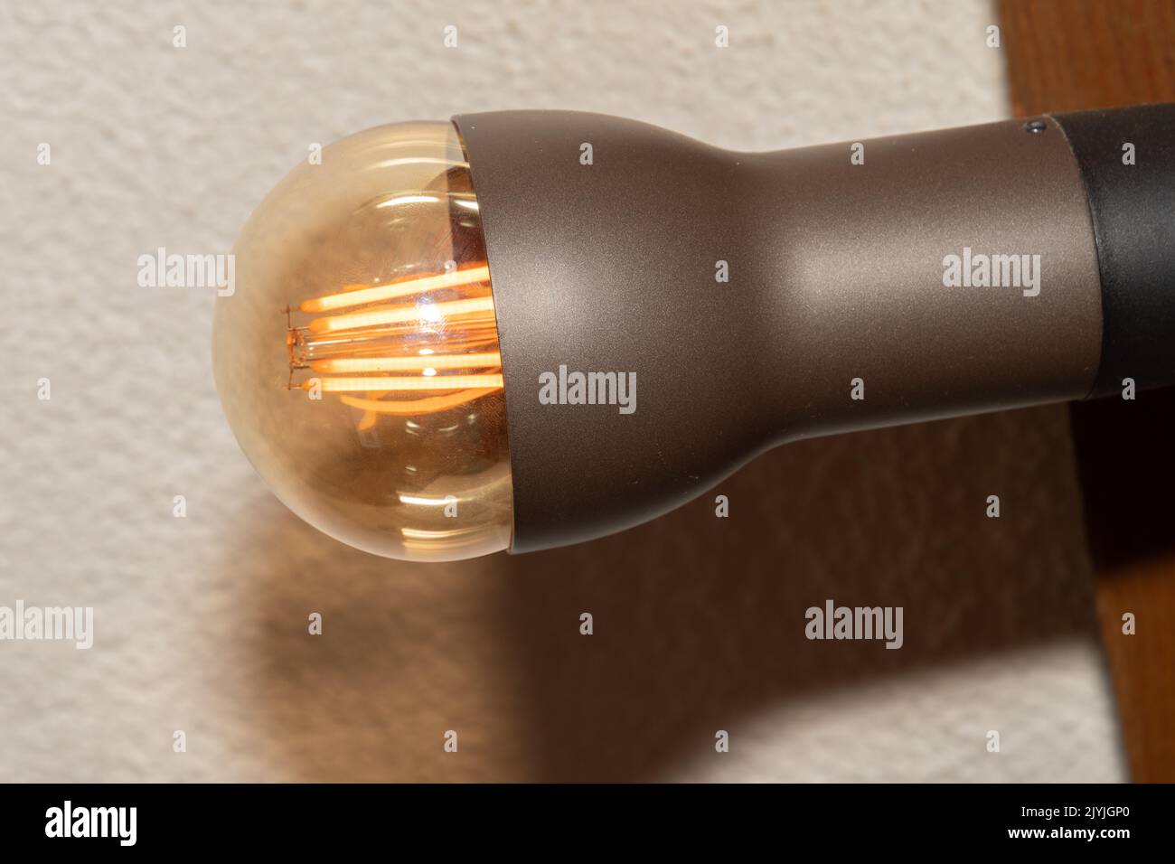 Vaduz, Liechtenstein, September 6, 2022 Light bulb is illuminating a room in the darkness Stock Photo
