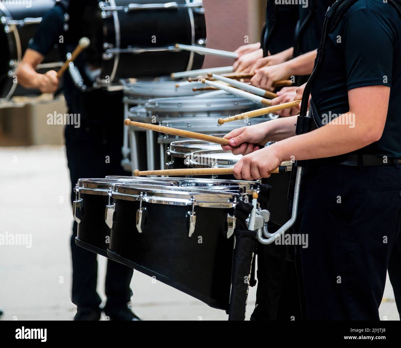 section of a marching band drum line warming up for a parade Stock