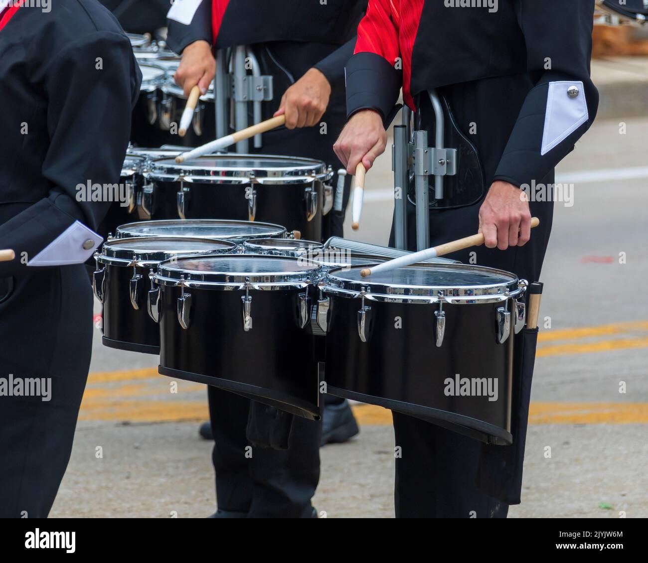snare section of a marching band drum line warming up for a parade