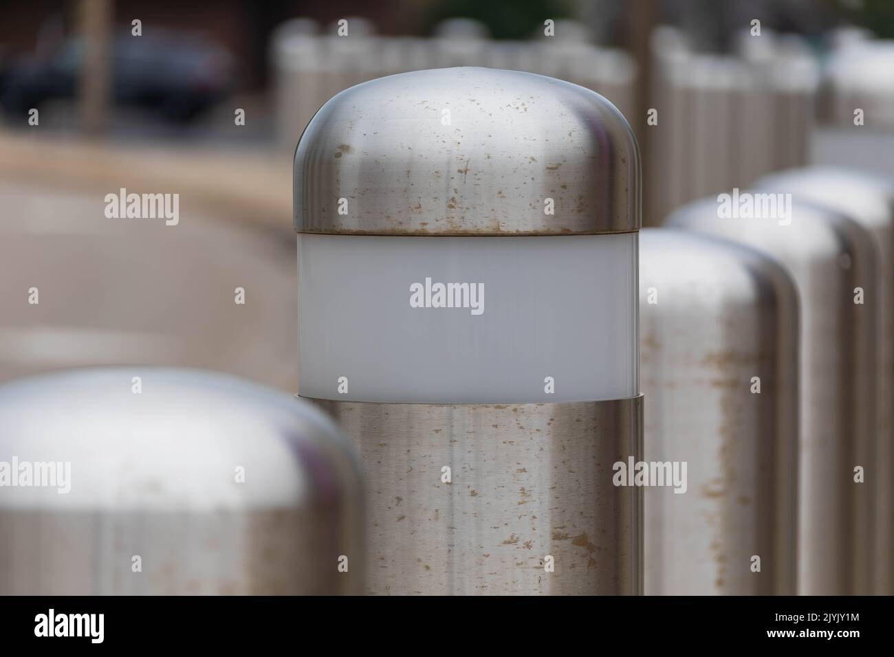 some of the barriers in this row of traffic barriers have lights in