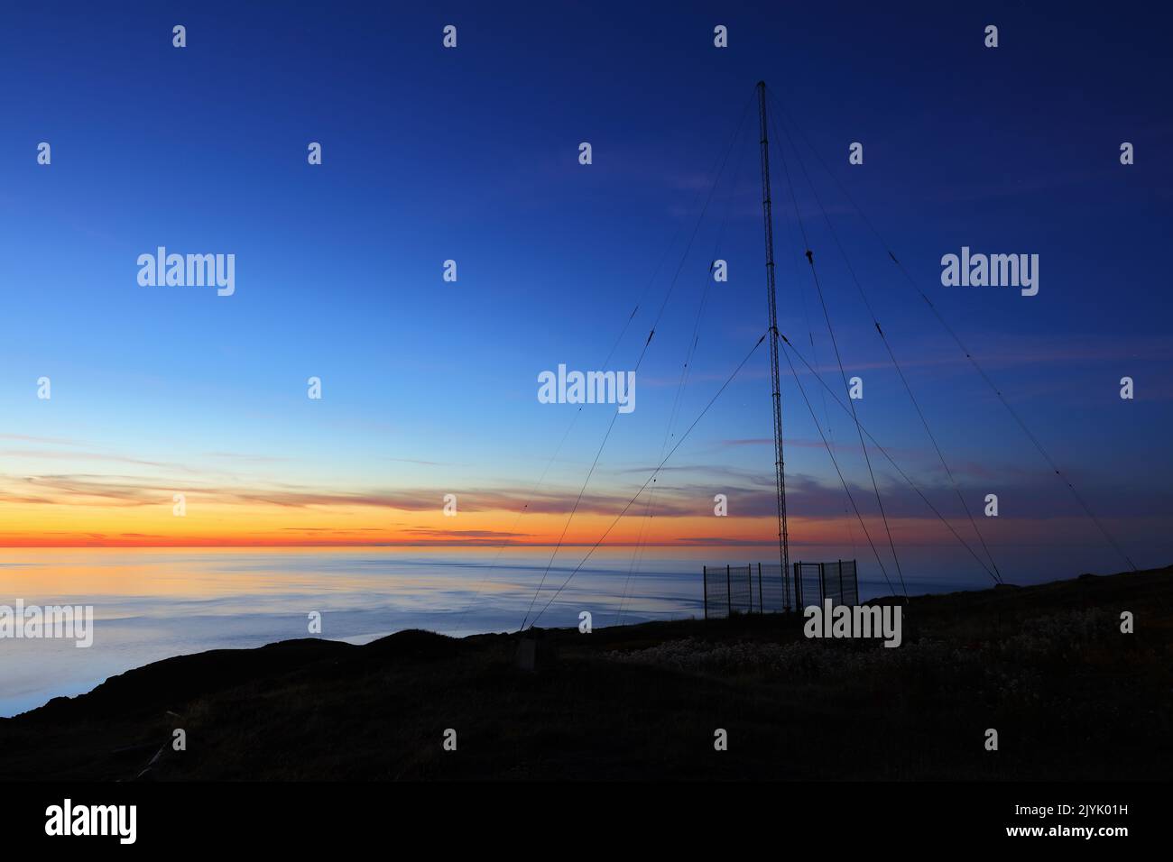 Stunning Sunset with a radio antenna at Point Lynas, Anglesey, North Wales, UK. Stock Photo