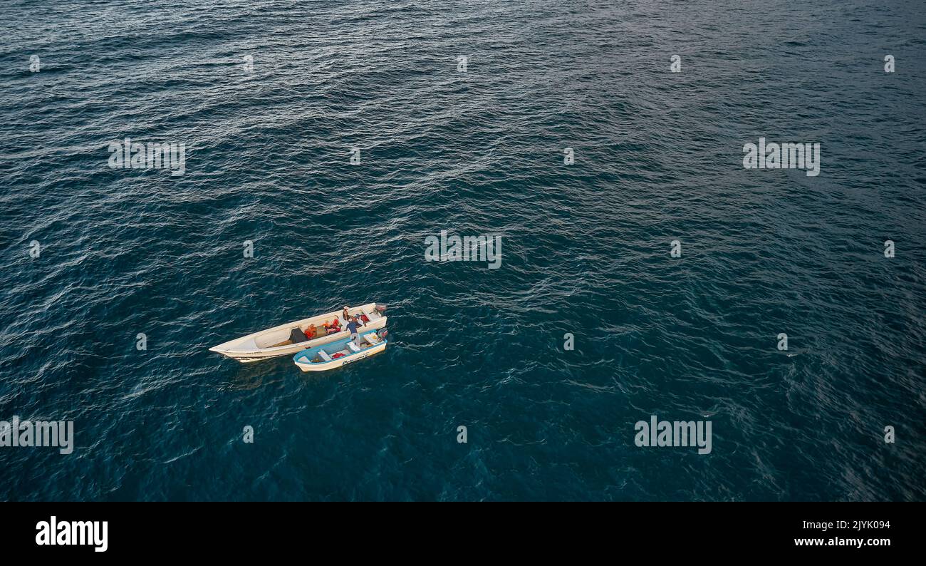 Aerial view of traditional fishing boat in Caraballeda with crystal clear turquoise sea, La Guaira, Venezuela. Stock Photo