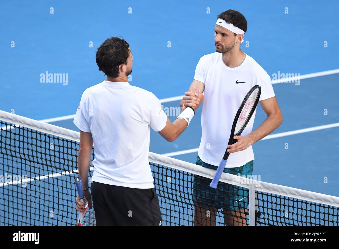 Grigor Dimitrov (R) of Bulgaria shakes hands with Dominic Thiem of Austria after winning his fourth Round Mens singles match on Day 7 of the Australian Open at Melbourne Park in Melbourne,