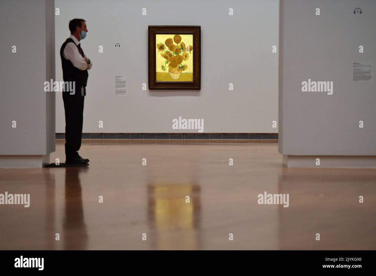 A guard stands by “Sunflowers” by Vincent Van Gogh in the Botticelli to