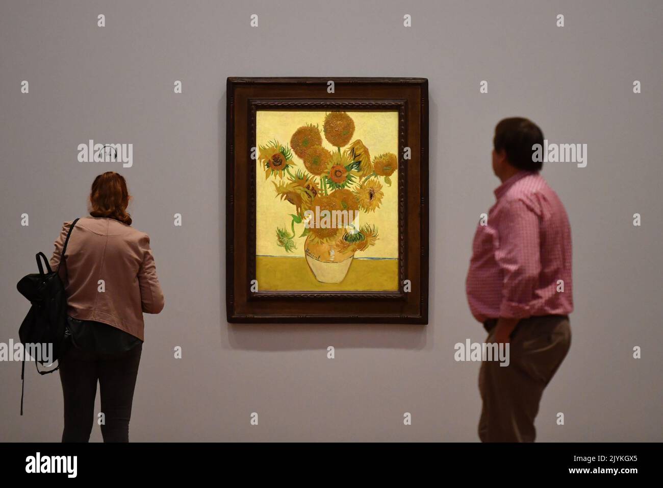 Members of the public look at “Sunflowers” by Vincent Van Gogh in the